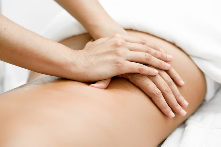 Young woman receiving a back massage in a spa center